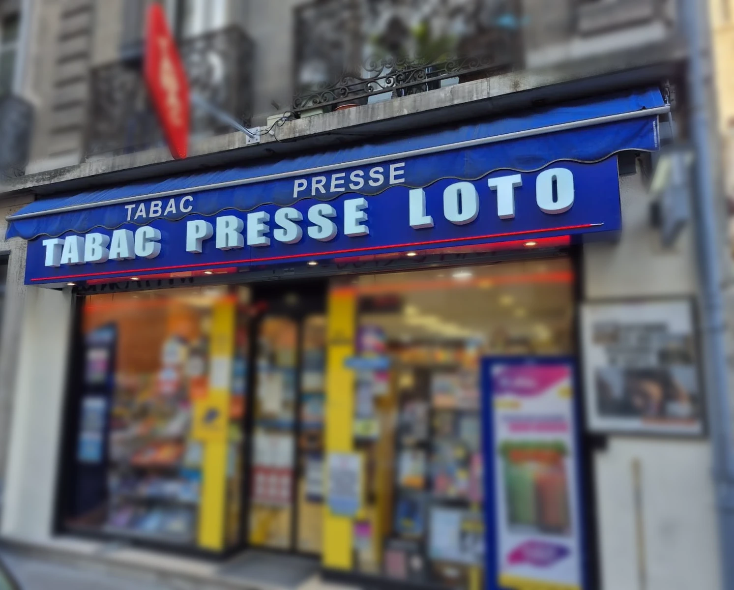 Dieselbe Fassade, von Lumisign in Dijon umgesetzt: Schild TABAC PRESSE LOTO über der blauen Markise